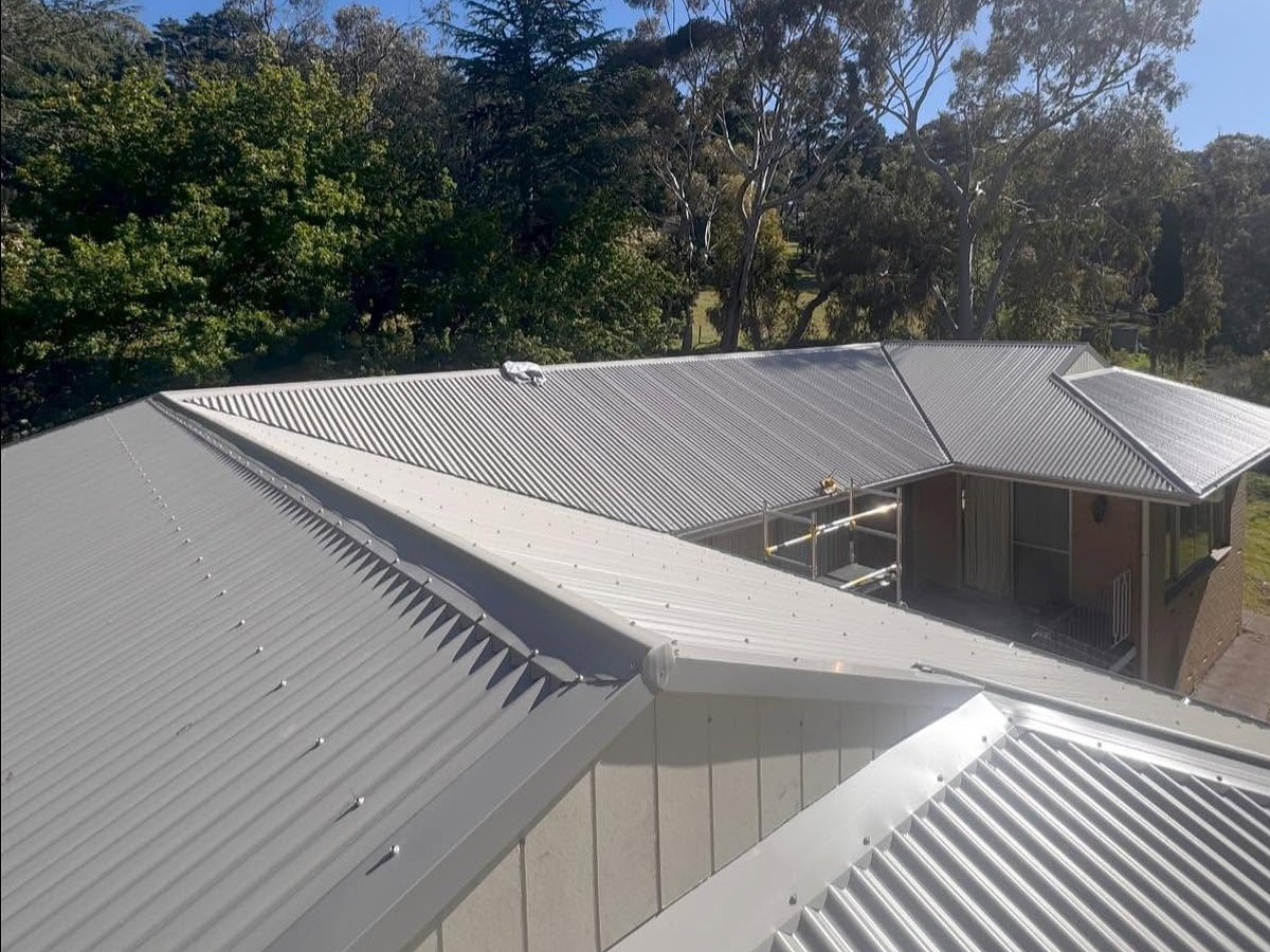 The same home with its new corrugated metal roof